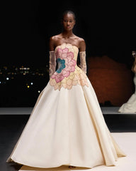 The side view of the elegant beige satin dress, highlighting the fabric's sheen.