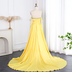 The full length of the satin formal dress, showing the flowy skirt and sweep train.