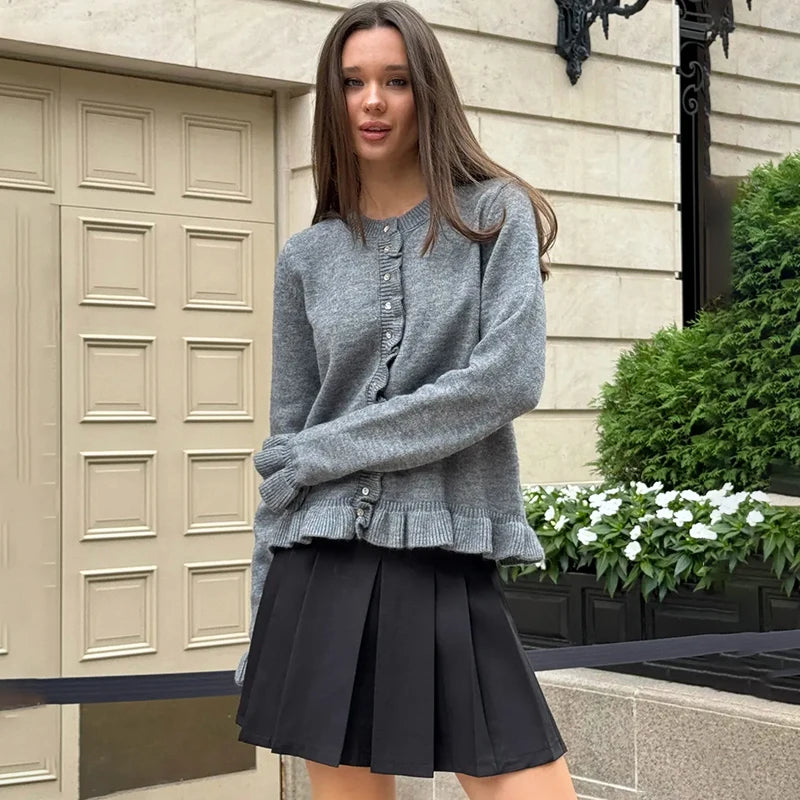 Close-up of frill trim detailing along cardigan placket and hem