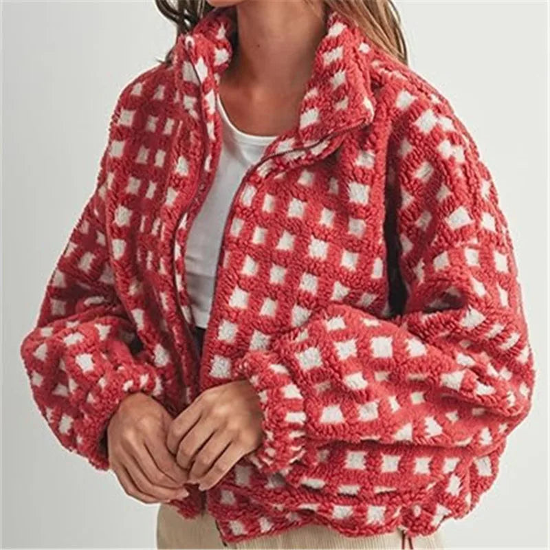 Red and white checkered fleece jacket worn by a person on a light gray background