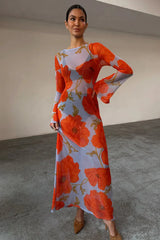full length poppy print maxi styled with sandals in a garden setting