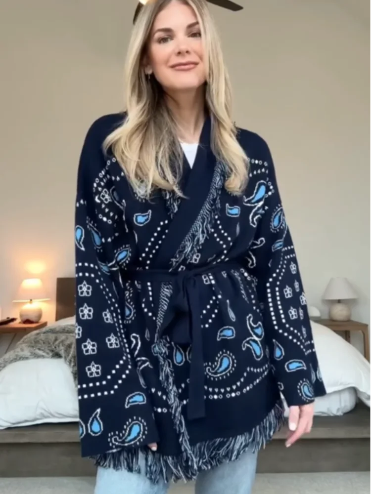 Woman wearing a navy blue patterned scarf in a bedroom setting