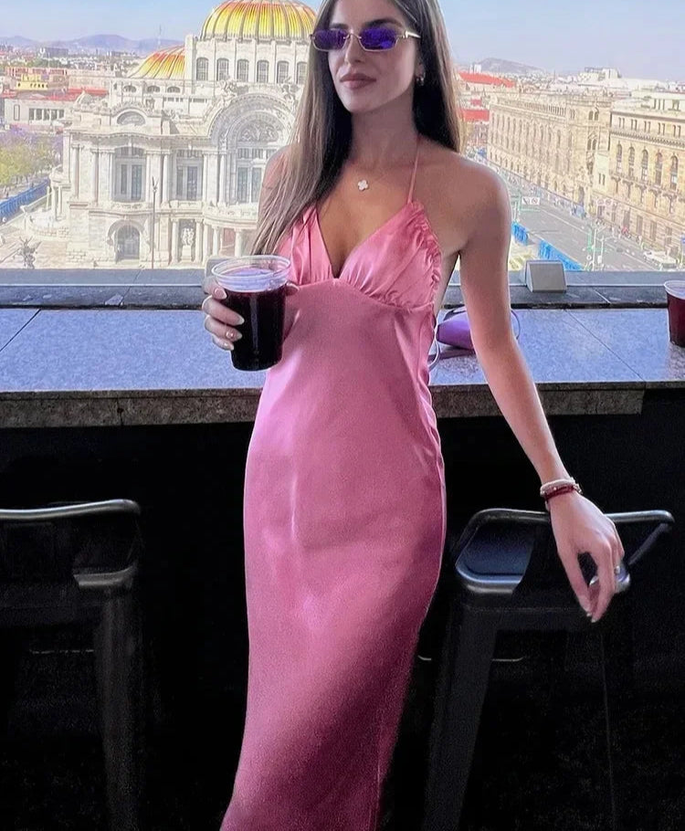 Glossy pink midi dress shown with pearl bag for a trendy look