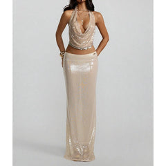 Editorial shot of gold sequin halter top styled with layered necklaces