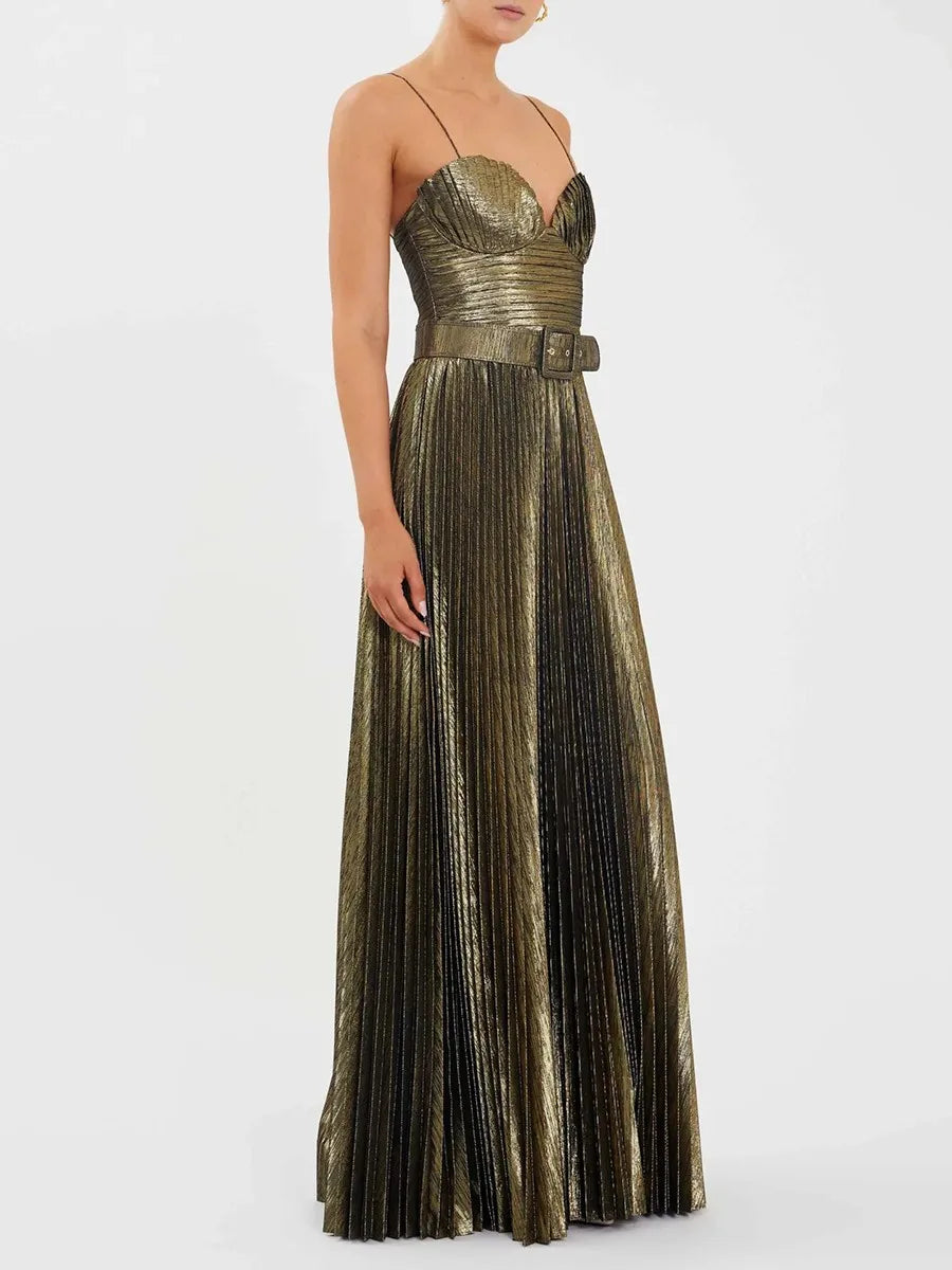 Full-length view of a gold belted evening gown with flowing pleats.