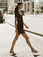 Gold button detail mini dress showcased for modern casual style