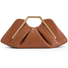 Gold handle sculptural clutch bag styled for day or evening outings