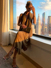 Front view of a sleeveless ruched cocktail dress with halter neckline