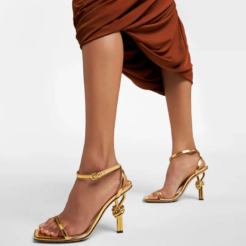 Gold sculptural heel party sandals styled for formal events