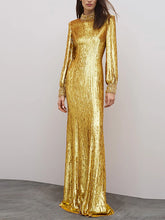 Gold sequined long sleeve maxi dress styled on a model against a soft neutral backdrop.