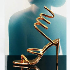 Gold spiral ankle heeled sandals styled for parties and events