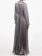 Pleated maxi dress featuring a defined waist and clean tailored finish