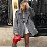 Gray double breasted blazer styled for streetwear over mini dress