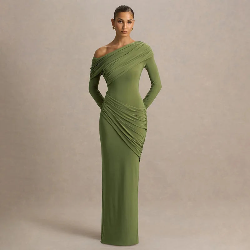 Editorial shot of green one-shoulder maxi dress styled indoors