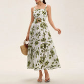 Woman wearing a green floral belted maxi dress styled for a summer brunch with a white background
