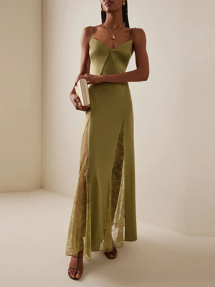 Woman in green maxi dress with lace panels and high slit