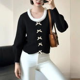 A woman wearing a sweet-style hairy-edge knitted cardigan with a butterfly bow.