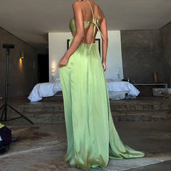 Backless halter dress with flowing movement and soft drape