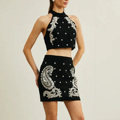 Close-up of the black halter top highlighting bead embellishments and clean neckline finish.