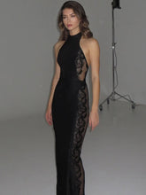 Studio front view of a black halter bodycon maxi dress with lace side panels, creating a sleek, elongated silhouette.