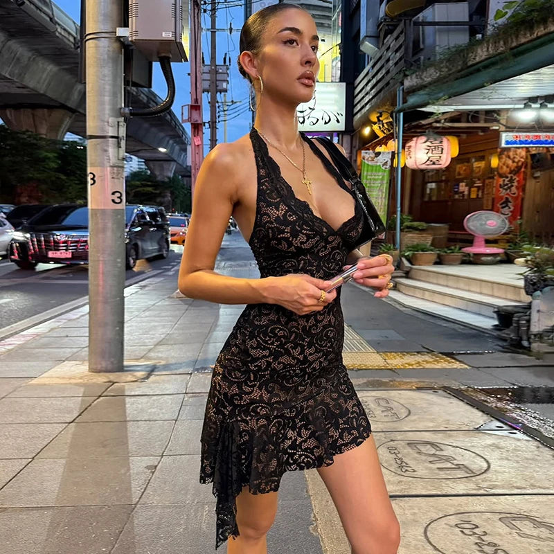 Halter neck black lace dress captured in bold city night look