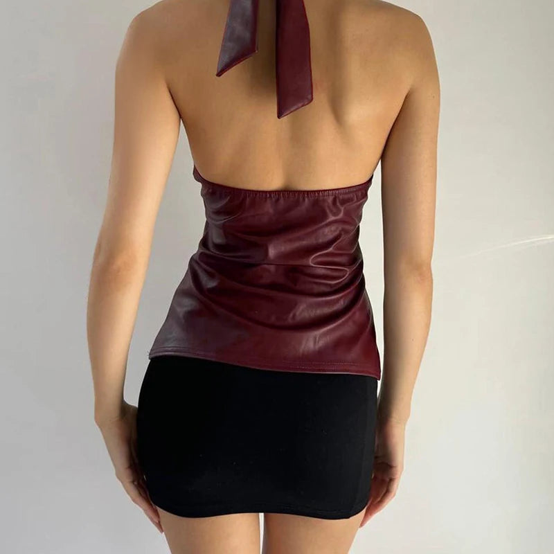 A close-up of the halter neck and lace-up detail on the PU leather top.