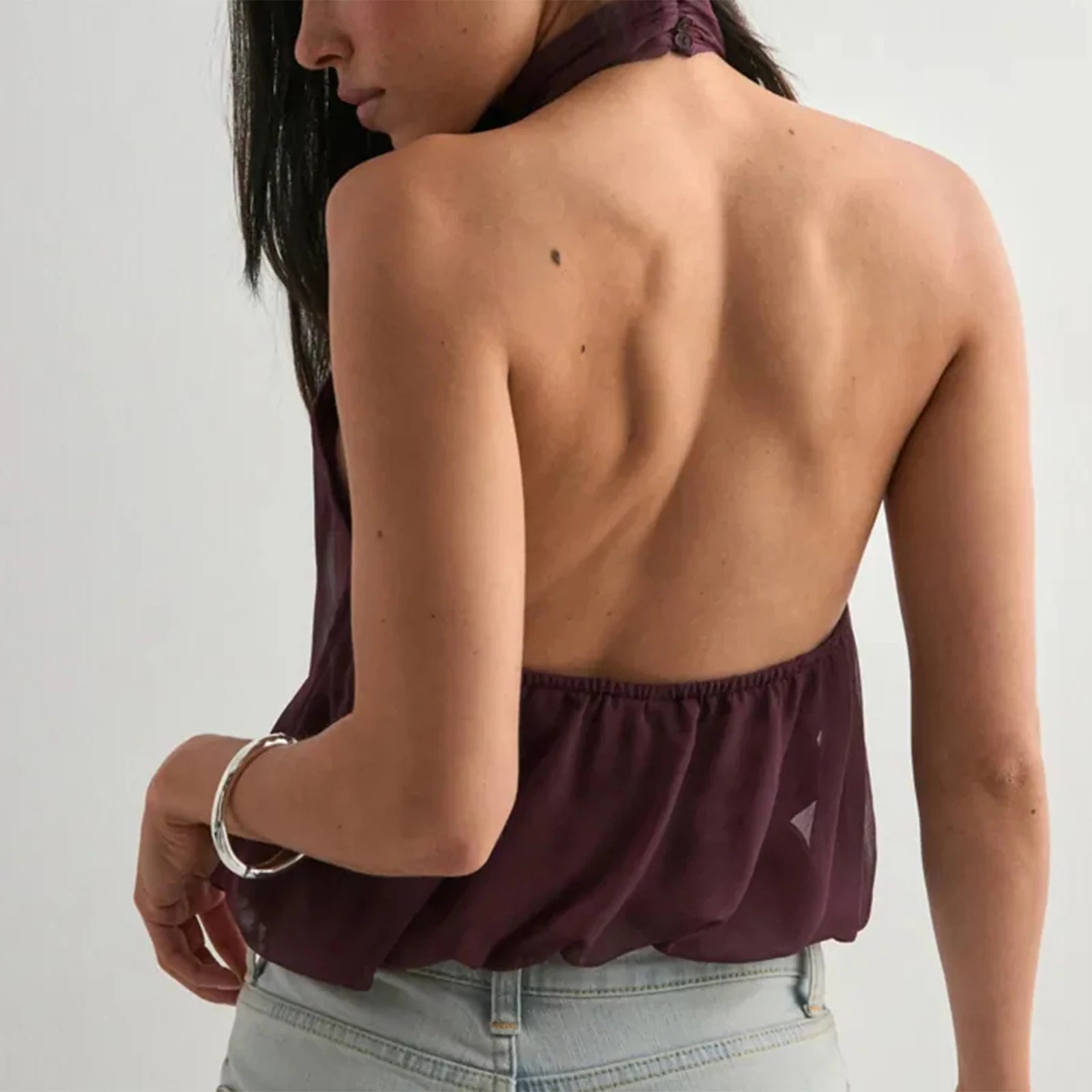 A close-up of the halter neck strap detail on the top.