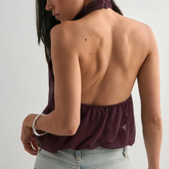 A close-up of the halter neck strap detail on the top.