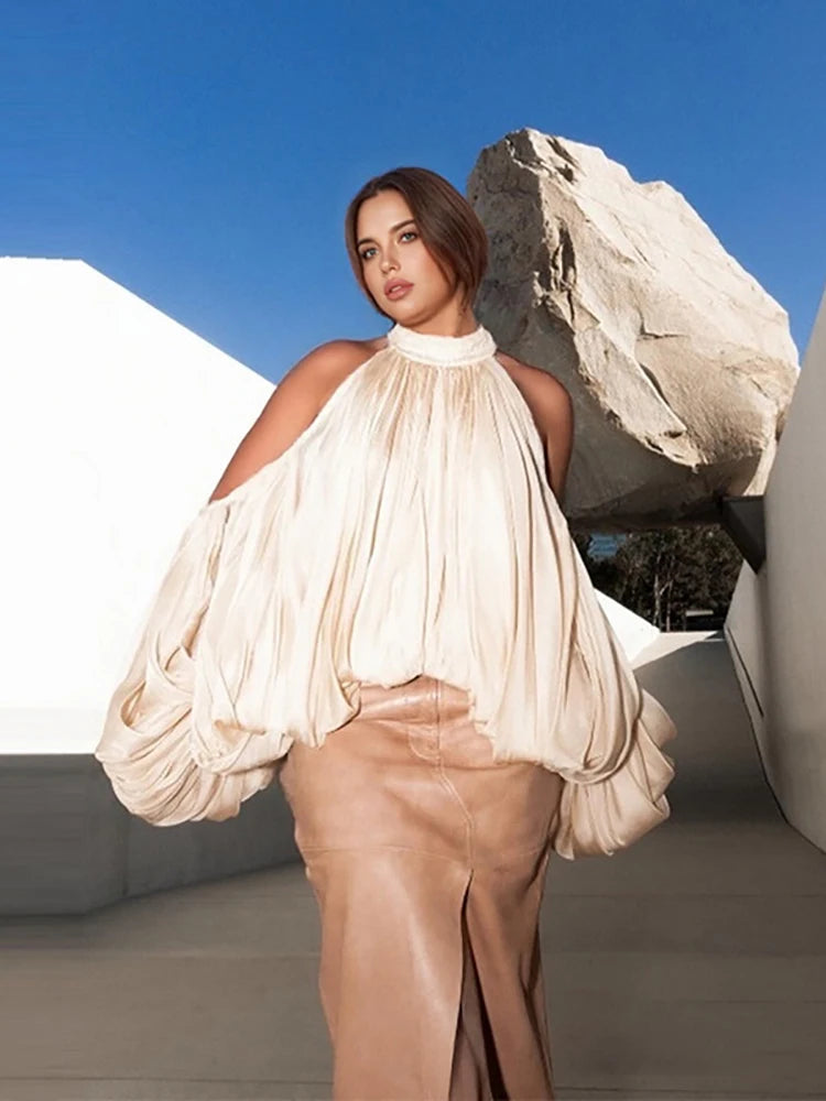 A woman modeling a halter puff sleeve mini top.