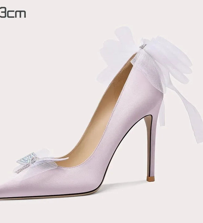Handmade purple stiletto shoes with oversized white bows