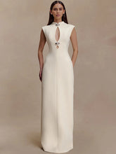 Sleeveless high-collar maxi dress with a vertical cut-out shown in a studio setting, highlighting its clean lines and elongated silhouette.