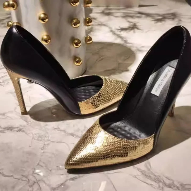 A front view of a high-heel pump, highlighting the thin heel and pointed toe.