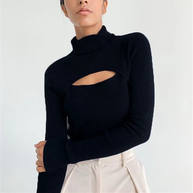 Model wearing a black high-neck knit sweater with a front cut-out, styled with tailored trousers against a clean studio backdrop.