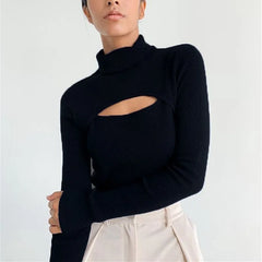 Model wearing a black high-neck knit sweater with a front cut-out, styled with tailored trousers against a clean studio backdrop.