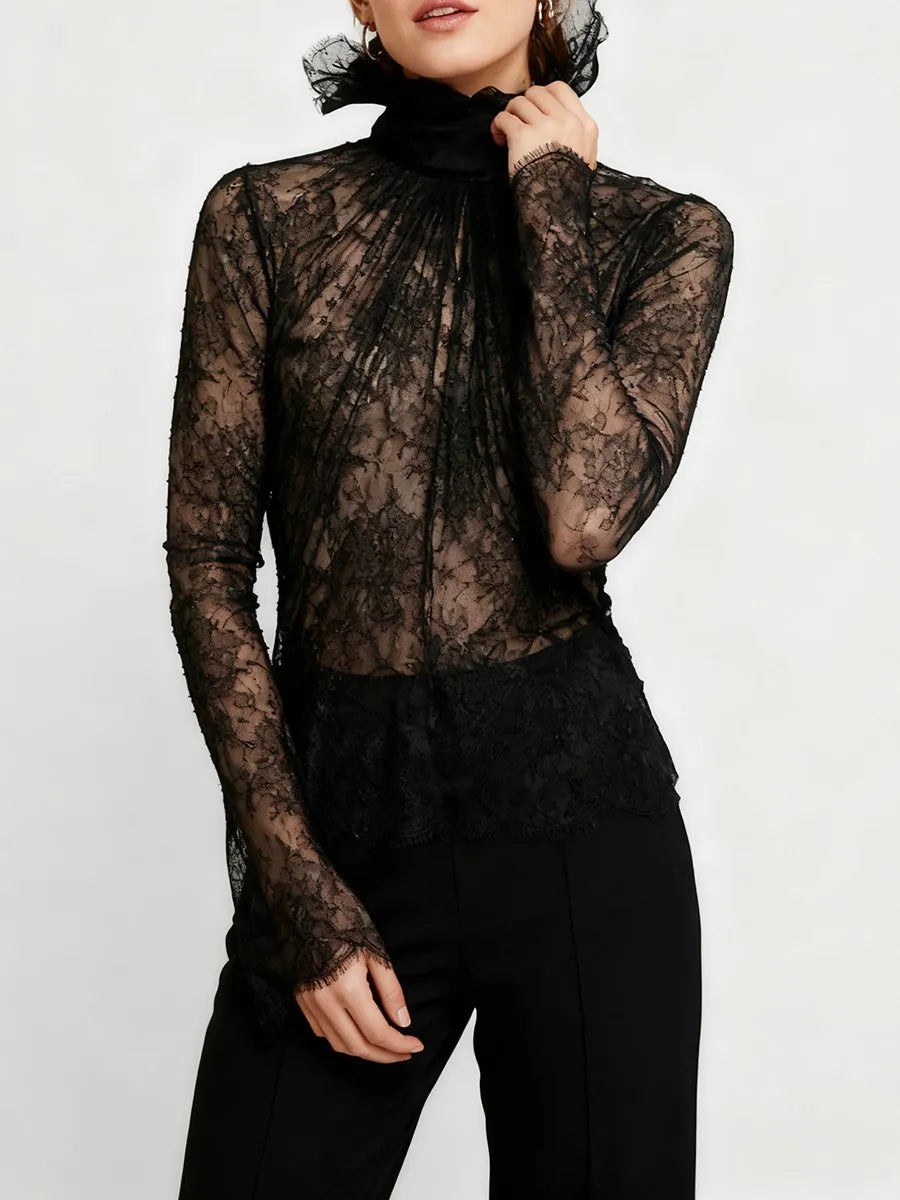 Detailed shot of the ruffled high neck and lightweight lace fabric emphasizing its refined, statement-making finish.