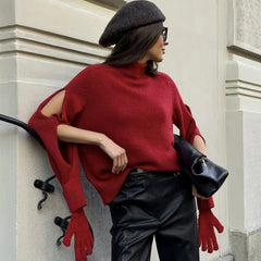 Model wearing a high-neck knit sweater with integrated glove sleeves, styled casually against an urban backdrop
