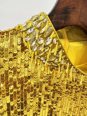 Elegant gold sequin gown styled for gala or red-carpet occasions.