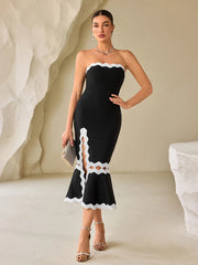 Woman wearing a hollowed-out curve party dress with sculpted fit and contrast details in a neutral setting