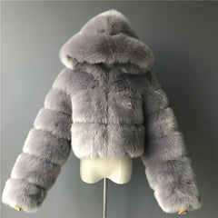 Fluffy hooded faux fur coat on mannequin