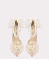 Ivory flower bow wedding pumps styled for bridal celebrations