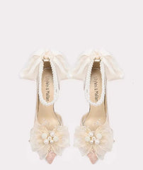 Ivory flower bow wedding pumps styled for bridal celebrations