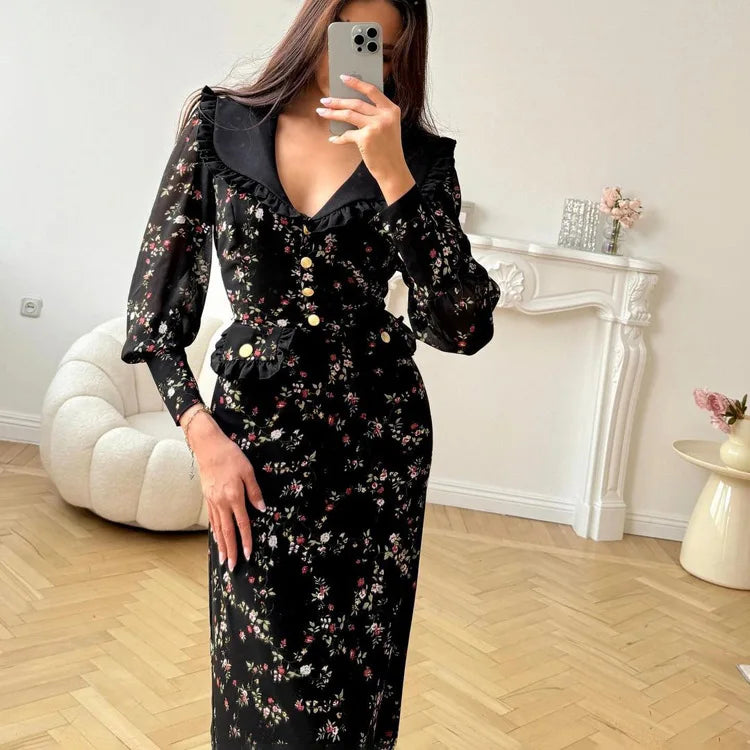 A woman taking a mirror selfie wearing a Junior retro style casual dress with a ruffled lapel and printed fabric in a room with a white fireplace and decorative items.