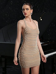 Woman wearing a pearl-embellished dress standing in front of a grand piano.