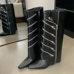 Close-up shot of the knee-high boots showing the pointed toe and wedge heel.