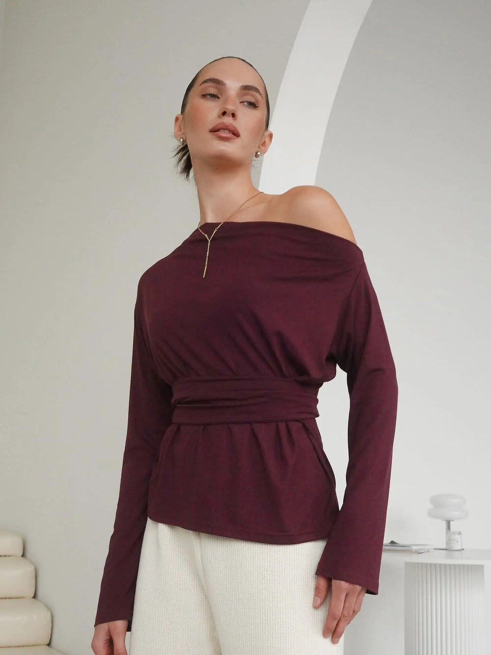 Fabric close-up revealing the fine knit texture and stretch of the top.