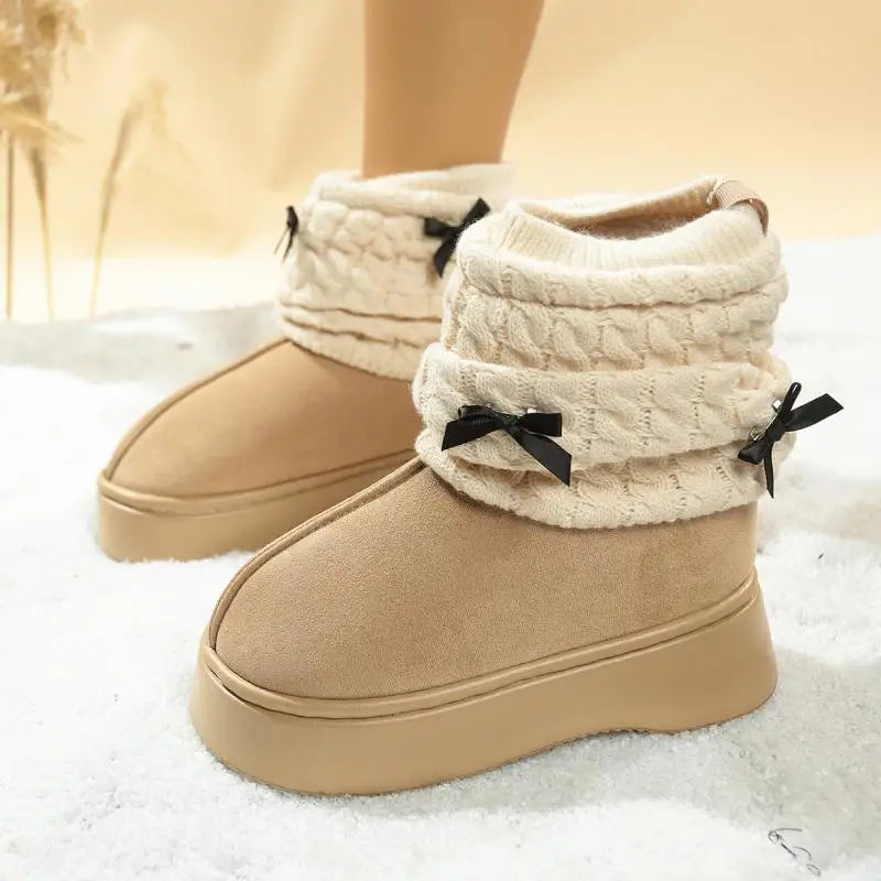 Side view of women’s winter snow boots in faux suede with bow accent