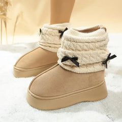 Side view of women’s winter snow boots in faux suede with bow accent