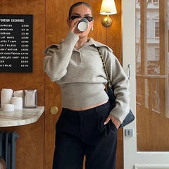 Knitted polo sweater showing relaxed collar and slim silhouette