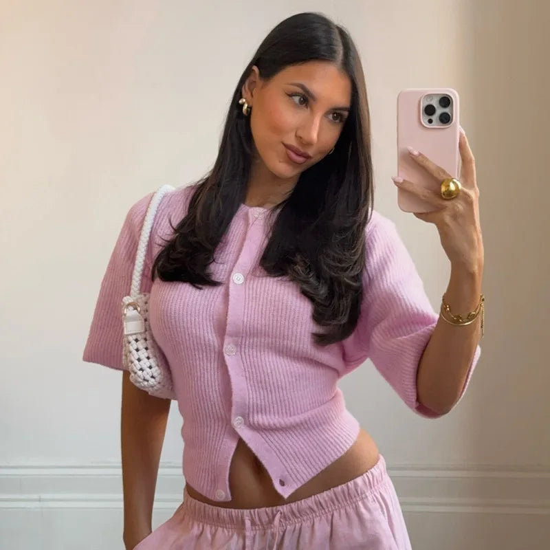 A woman modeling a knitted short-sleeve T-shirt with single-breasted buttons.