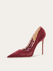 A close-up of the lace and pointed toe detail on the shoe.